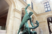 Bronze sculpture of man fighting with snake.
