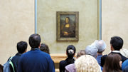 Spectators looking at The Mona Lisa at the Louvre