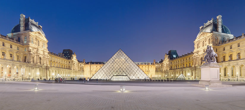 Exterior of the Louvre Museum with glass pyramid.