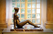 Bronze sculpture of a woman with window